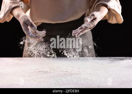 Sprinkle the flour evenly on the kitchen counter, the process of making Chinese traditional cuisine three fresh dumplings - stock photo Stock Photo