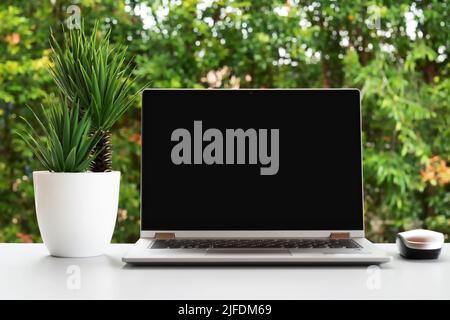 Laptop with blank black screen of top of table Stock Photo