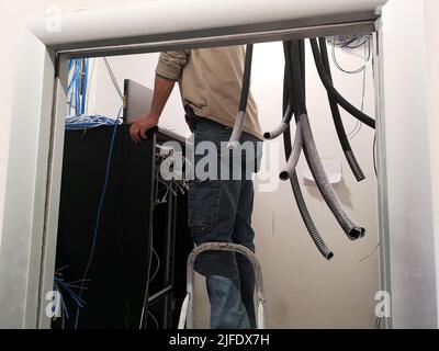 A technician working in the router cabinet Stock Photo