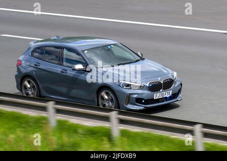 Police, unmarked vehicle. Motorway Patrol Car with hidden blue lights. 2020 Grey BMW M135i X drive Auto Start Stop 1998cc petrol hatchback driving at speed on the M6 motorway in Lancashire, UK Stock Photo