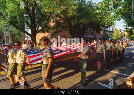 Lititz, PA, USA – July 1, 2022: Boy Scouts carry a large US Flag in the annual 4th of July Celebration Parade in Lititz, Lancaster County, PA. Stock Photo