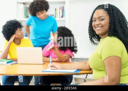 Laughing african american computer science student with group of coding students at university Stock Photo