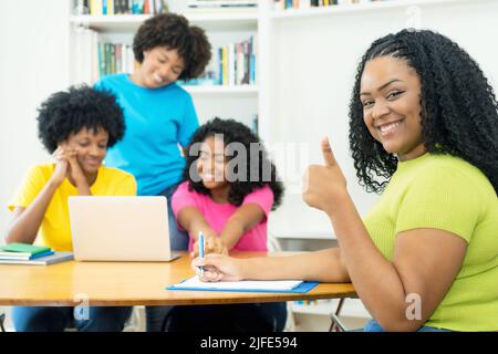 Motivated african american computer science student with group of coding students at university Stock Photo