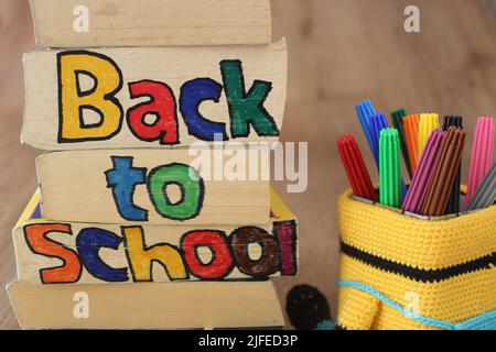 Back to school, ready for school concept background with books. Full of pencil box with colorful pencil on wooden table. Stock Photo