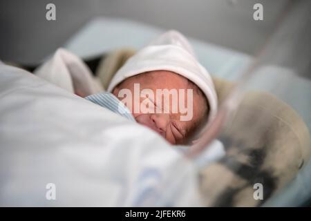 Premature newborn baby crying Stock Photo