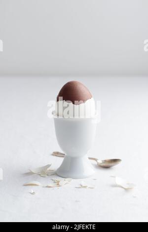 Chocolate egg on white eggstand holder with copy space Stock Photo