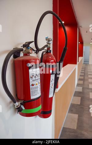 Fire extinguisher and gas pump system on the wall. Powerful emergency fire extinguisher equipment. Fire retardant. Fireproof. Stock Photo