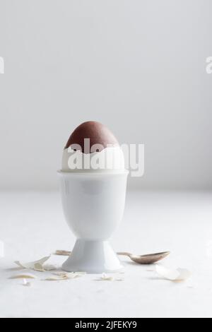 Chocolate egg on white eggstand holder with copy space Stock Photo