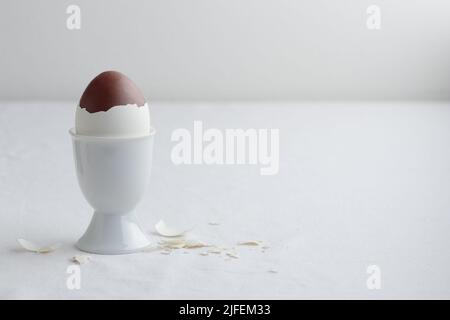 Chocolate egg on white eggstand holder with copy space Stock Photo