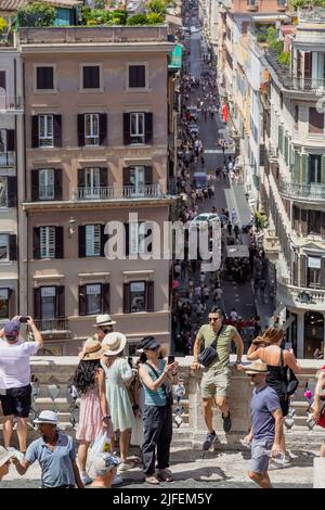 Rome, Italy. June 29, 2022: Tourists looking out on the terrace of the Spanish Steps, Trevi Fountain and Via Condotti in Rome. Stock Photo