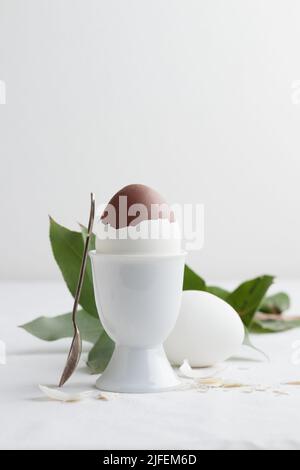 Chocolate egg on white eggstand holder with copy space Stock Photo