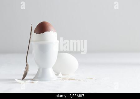 Chocolate egg on white eggstand holder with copy space Stock Photo