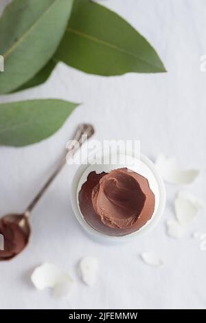 Chocolate egg on white eggstand holder top view Stock Photo