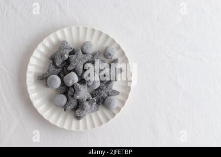 Salty liquorice salmiakki in Finnish in a white plate top view Stock Photo