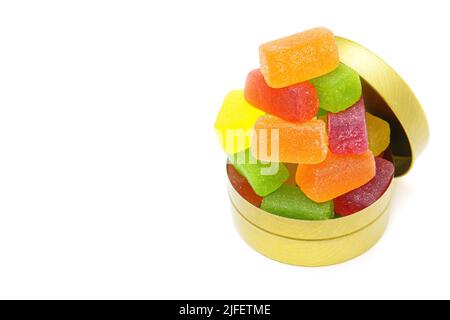 Mix of colorful jelly candies stacked in a round tin box isolated on white background with copy space. Stock Photo