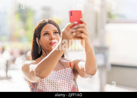 Transgender woman taking a selfie outdoors. Close up Stock Photo