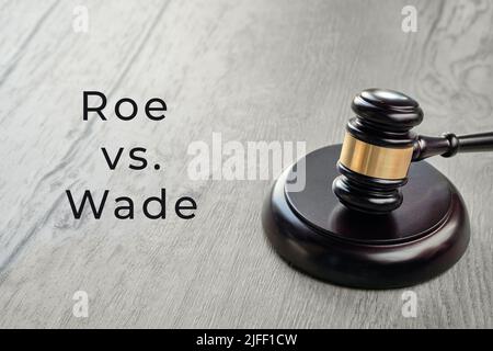 Roe versus Wade text. Law hammer on wooden table. Stock Photo