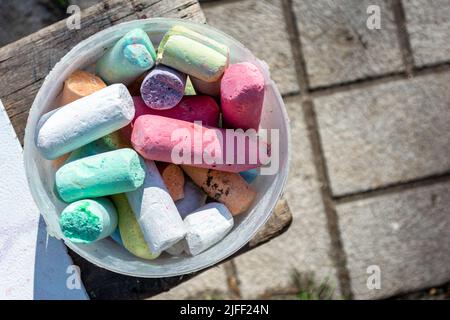 Colorful crayons in a plastic bucket. Top view. Stock Photo