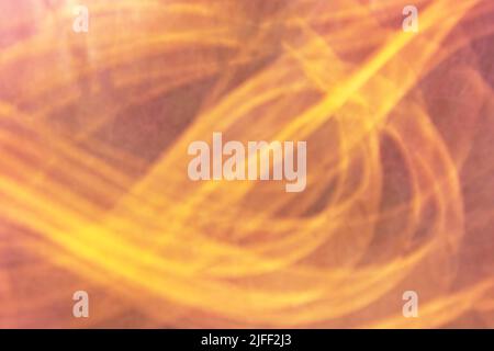 Blurred horizontal dark orange background in warm colors from chaotic yellow lines. Backdrop Stock Photo