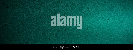 Rough plastered green wall. spotlight on dark green surface Stock Photo