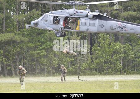 VIRGINIA BEACH, Va. (Jun. 29, 2022)- Explosive Ordnance Disposal Technicians assigned to Explosive Ordnance Disposal Mobile Unit (EODMU) 2 fast-rope from the cabin of an SH-60S Sea Hawk helicopter assigned to Helicopter Sea Combat squadron (HSC) 9. CRABEx is a training exercise that certifies Navy EOD units of action under Explosive Ordnance Disposal Group (EODGRU) 2, ensuring a ready and more lethal EOD force. Stock Photo