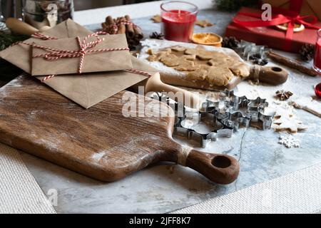 Close up of cutting board and cookie cutters. The concept of home comfort and Christmas holidays. Stock Photo