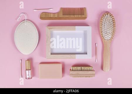Eco friendly wooden beauty and hygiene products like comb and soap arranged on pink background Stock Photo