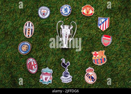 April 21, 2021, Moscow, Russia. UEFA Champions League Cup and emblems of top clubs on the green grass of the stadium. Stock Photo