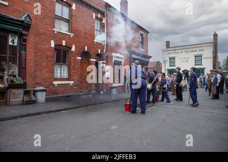 Dudley, West Midlands-united kingdom July 13 2019 1940's concept street scene house  fire being attended to vintage equipment Stock Photo