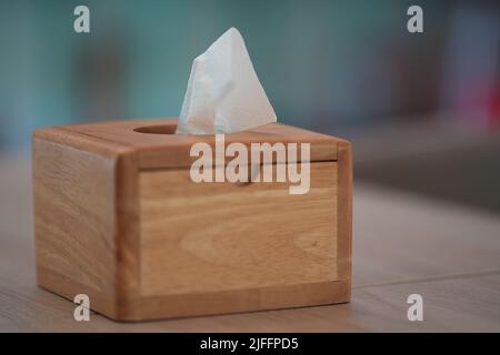 Wooden tissue box on blur background and copy space for put some text, close up. Stock Photo