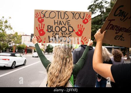 A pro choice protester marches in downtown Berkeley holding a placard reading ' Scotus you have blood on your hands' during the demonstration against the Supreme Courts recent decision to overturn Roe Vs. Wade. Protesters of all ages and gender, demonstrate against the recent decision to overturn Roe vs. Wade. Speeches and chants were expressed during the 2 mile walk from downtown to the University of Berkeley. Many cars and people watching were in support of the demonstrators. (Photo by Pat Mazzera/SOPA Images/Sipa USA) Stock Photo