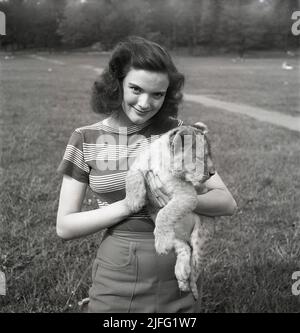 Doreen Denning. Swedish actress, 1928-2007. Pictured with a lion cub.  Sweden 1952. Kristoffersson ref BG15-2 Stock Photo