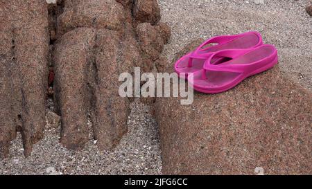 Pink sandals on Sardinia beach Stock Photo