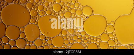 Yellow oil drops on the water surface Stock Photo