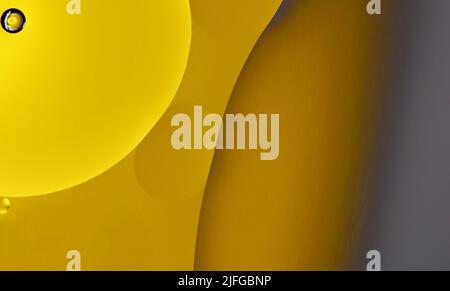 Yellow oil drops on the water surface Stock Photo