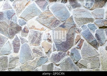 Gray stone texture, retro style. Brick wall background. Abstract rocks pattern. Grey stones, textured surface. Natural backdrop. Weathered facade buil Stock Photo