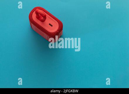 jerusalem-israel. 03-05-2021. top view of small and portable speaker from the jbl company - model go3 in red - on a blue background Stock Photo