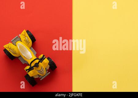 ATV-shaped toy on a yellow and red background Stock Photo