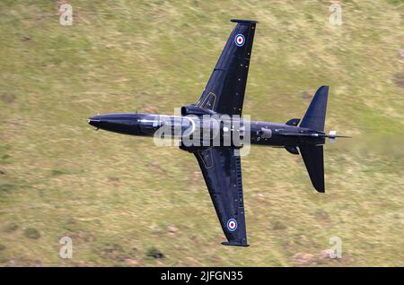 RAF Hawk T2 jet trainer, on a low level flying mission through the Welsh mountains/valleys of LFA7 Stock Photo