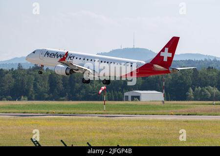 Zurich, Switzerland, May 20, 2022 Helvetic Airways Embraer E-190LR is arriving on runway 14 Stock Photo