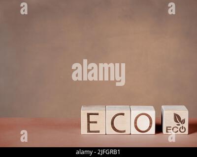 Text ECO on wooden blocks as a concept of eco friendly production and consumption Stock Photo