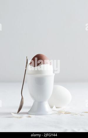 Chocolate egg on white eggstand holder with copy space Stock Photo