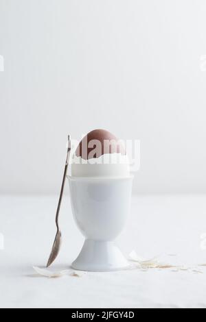 Chocolate egg on white eggstand holder with copy space Stock Photo