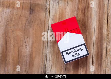 PHARE, THAILAND - MARCH 9, 2016. Pack of Marlboro Cigarettes on Wooden Table, made by Philip Morris. Marlboro is the largest selling brand of cigarett Stock Photo
