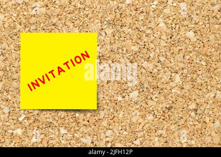 Yellow note paper with word invitation on cork board background with copy space Stock Photo