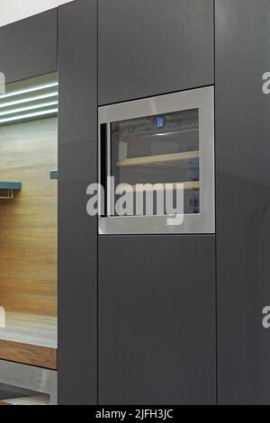 Wine chiller fridge built in black cabinets modern home kitchen Stock Photo