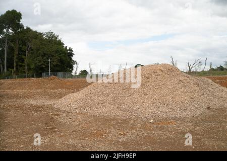 Wendover, Buckinghamshire, UK. 1st July, 2022. A huge pile of wood chippings from trees felled by HS2 at the ancient woodlands of Jones Hill Wood where anti HS2 protesters fought to save the woodlands for over two years. Locals are very distressed at the impact that HS2 is having on Wendover and the surrounding area as large parts  of the countryside have been taken by HS2 where they have cut down ancient woodlands, evicted badgers from their setts and destroyed wildlife habitats. Credit: Maureen McLean/Alamy Live News Stock Photo