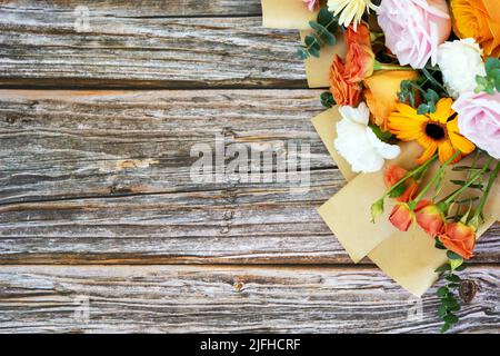 Mixed flower bouquet on top of wood background with copy space Stock Photo