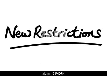 New Restrictions, handwritten on a white background. Stock Photo