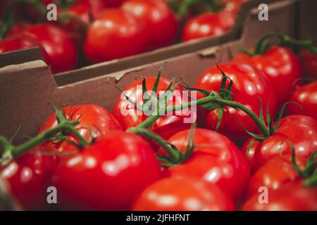 Close-up, tomatoes in a box on the counter. Stock Photo